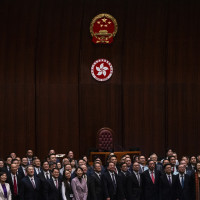 Hong Kong's Chief Executive John Lee, fifth foreground left, pose for photographs with lawmakers following the passing of the Basic Law Article 23 legislation at the Legislative Council in Hong Kong, Tuesday, March 19, 2024. 