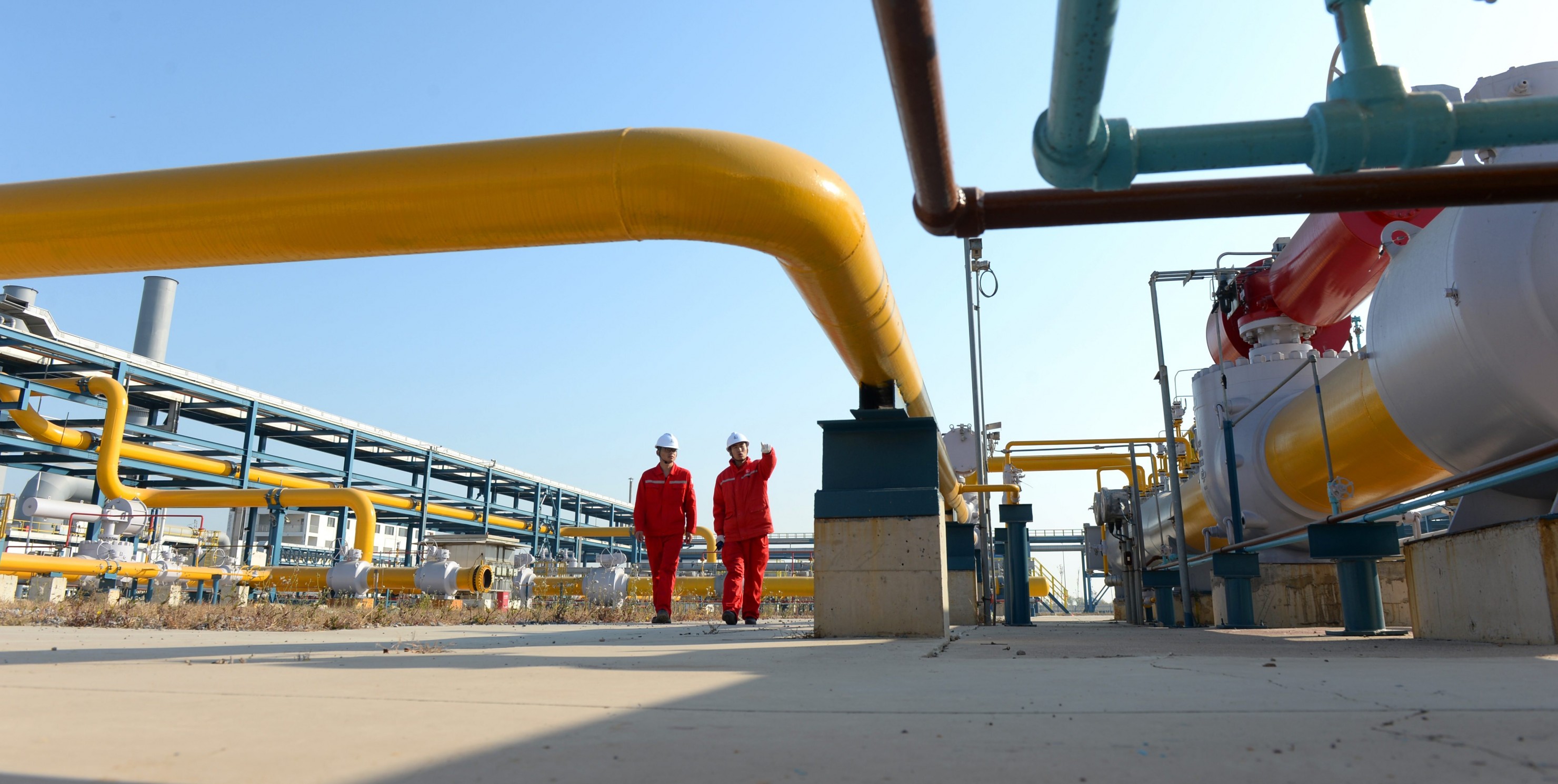 Technicians inspect pipelines at a liquefied natural gas (LNG) terminal operated by China Petrochemical Corporation (Sinopec Group)