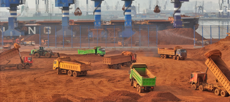 Trucks dump bauxite imported from Guinea into a pile at a ore dock in Yantai in eastern China's Shandong province, Wednesday, March 25, 2026. Bauxite smelters produce rare-earth elements (REEs) as a byâproduct, Credit:TANG KE / Avalon