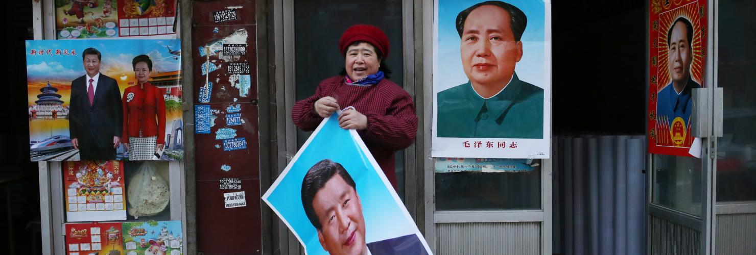 Portraits of Mao and Xi on posters