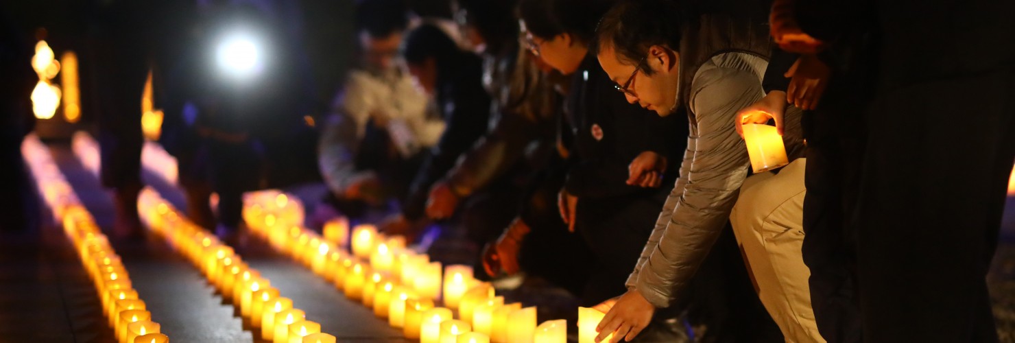 People put down candles at Nanjing Massacre memorial