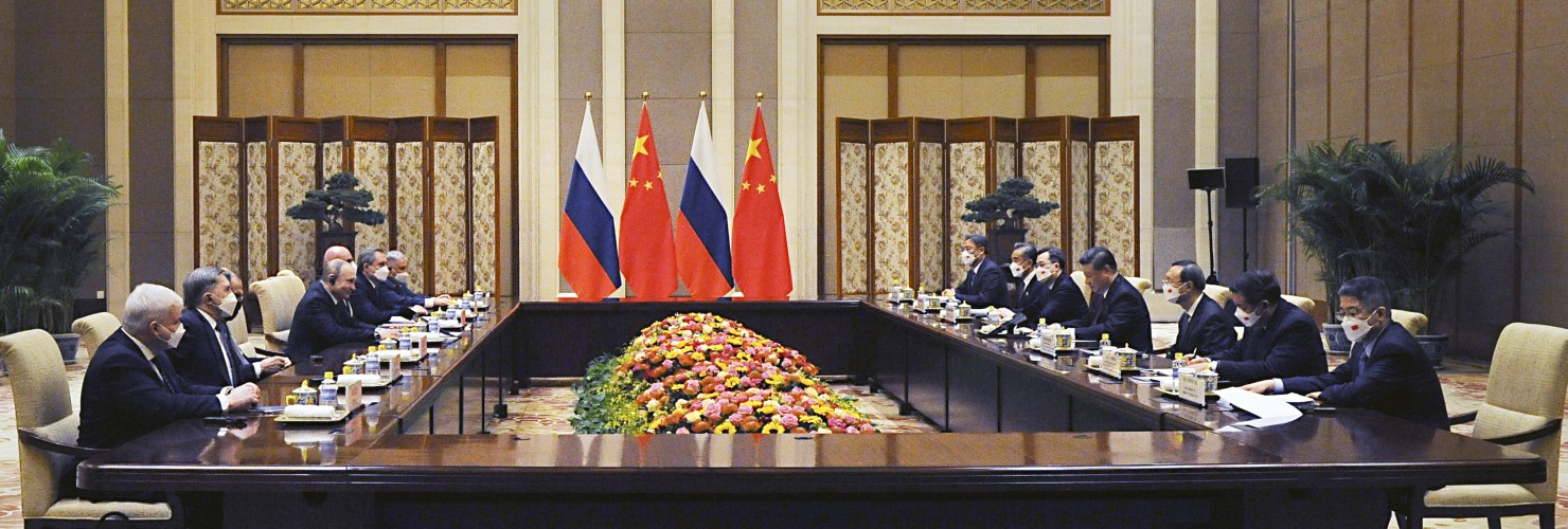 Chinese President Xi Jinping, fourth right, and Russian President Vladimir Putin, fourth left, attend talks in Beijing, China, Friday, Feb. 4, 2022.