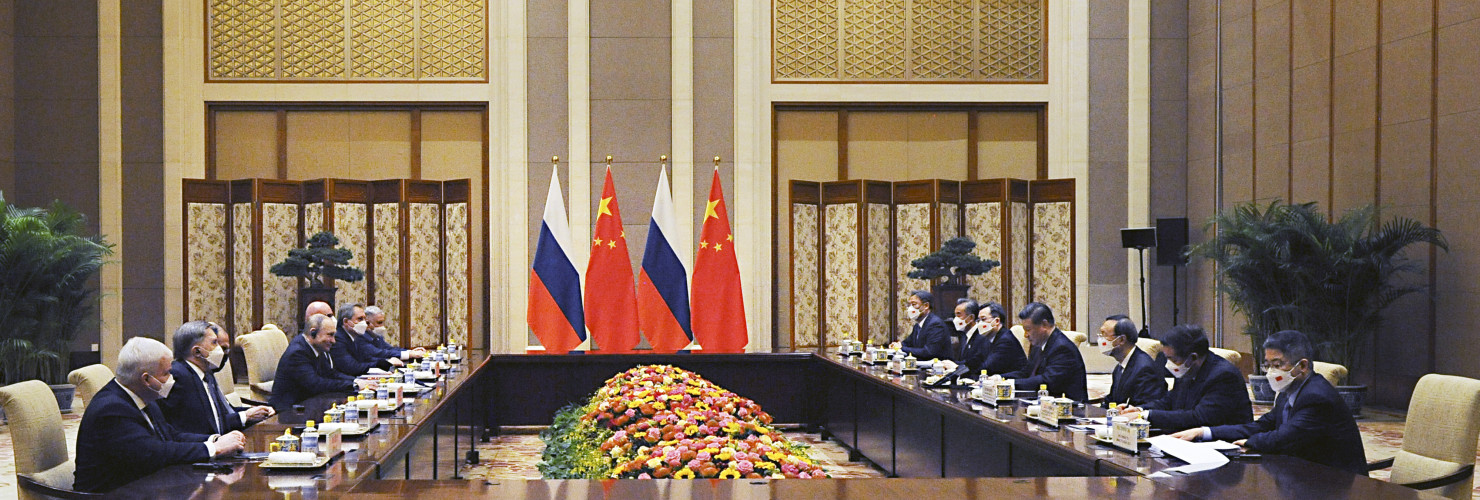 Chinese President Xi Jinping, fourth right, and Russian President Vladimir Putin, fourth left, attend talks in Beijing, China, Friday, Feb. 4, 2022.