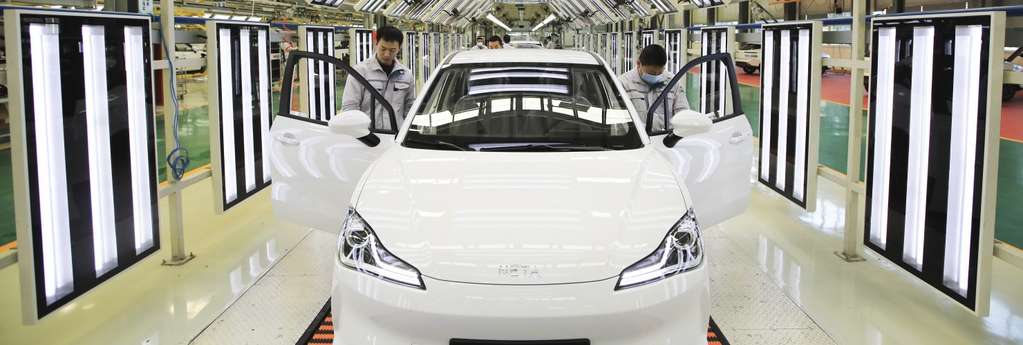 Employees work on the assembly line of Neta electric car at a factory of Hozon New Energy Automobile Co., Ltd on February 19, 2021 in Jiaxing, Zhejiang