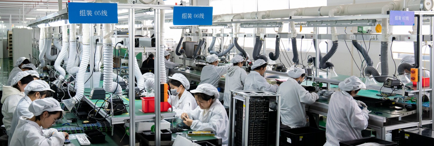 Workers work on a production line to produce electrical products for domestic and Southeast Asian markets in Nantong