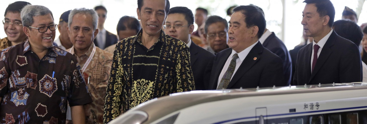 Indonesian President Joko Widodo, center, inspects a model of the high-speed train which will connect the capital city of Jakarta to the country's fourth largest city, Bandung, along with from left to right, West Java Governor Ahmad Heryawan, Director of Indonesia China High Speed Train Hanggoro Budi Wiryawan, President of China Railway Corp.