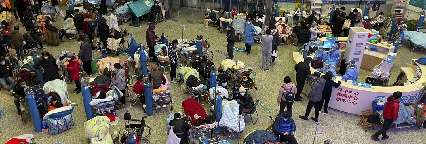 Patients, most of them elderly with covid symptoms, are crowded at the Changhai Hospital hall as they receive medical treatment, in Shanghai, China, Tuesday, Jan. 3, 2023