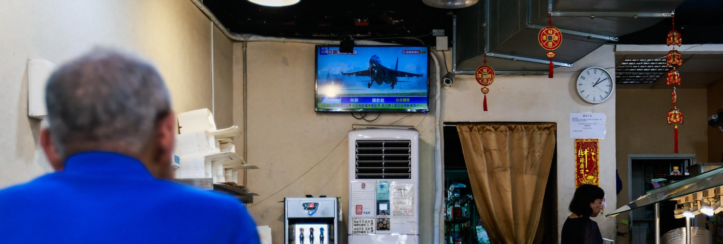 A man watches a TV screen showing a news report of the Chinese live-fire military exercises near Taiwan, at a restaurant in Taipei, Taiwan, on October 22, 2024.