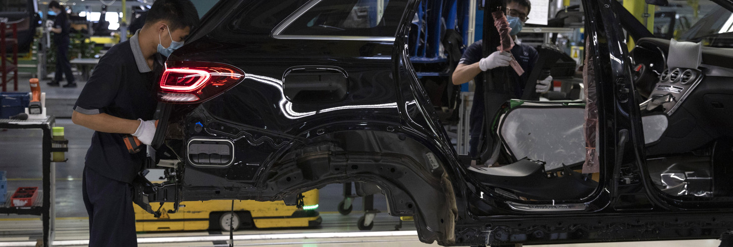 Workers assemble cars at a Beijing Benz Automotive Co. Ltd factory, a German joint venture company for Mercedes-Benz, in Beijing