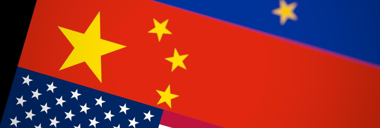 Blurred USA, China and EU flags together on black background