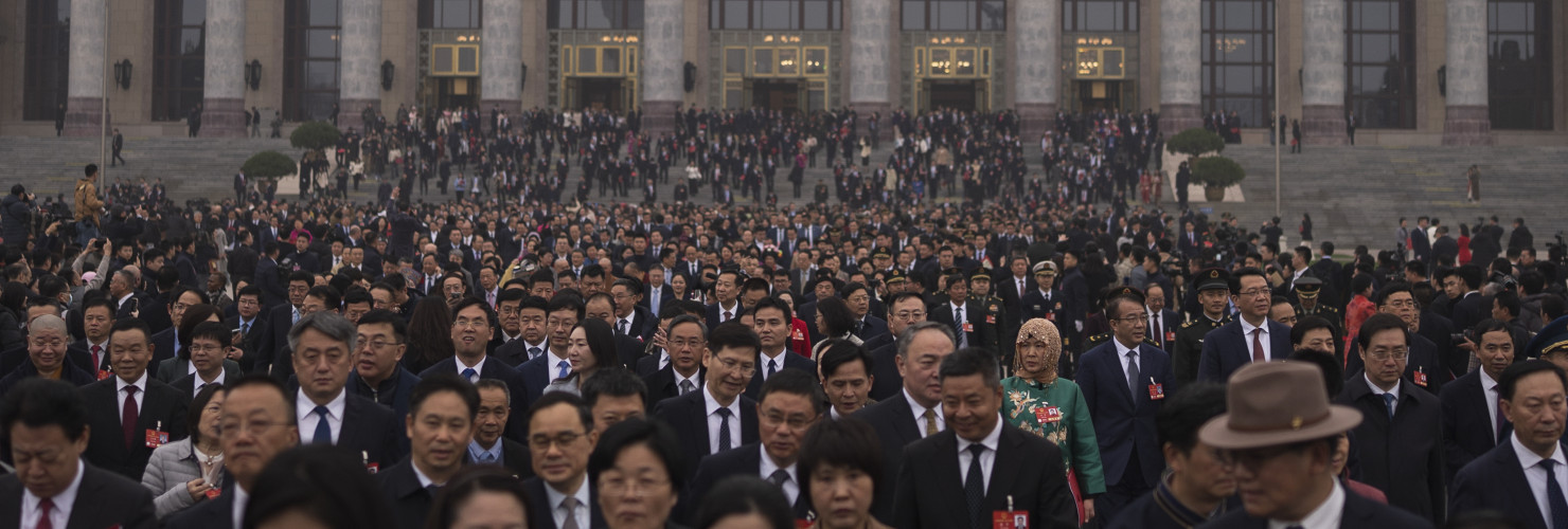 Delegates leave the Great Hall of the People after attending the closing ceremony of the National People's Congress in Beijing, Tuesday, March 11, 2025.