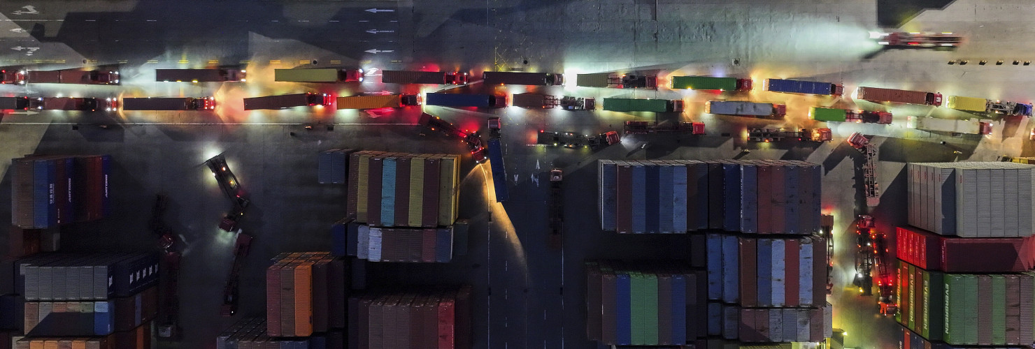 Trucks line up to depart from a container terminal in Nanjing in east China's Jiangsu province on Tuesday, April 8, 2025.