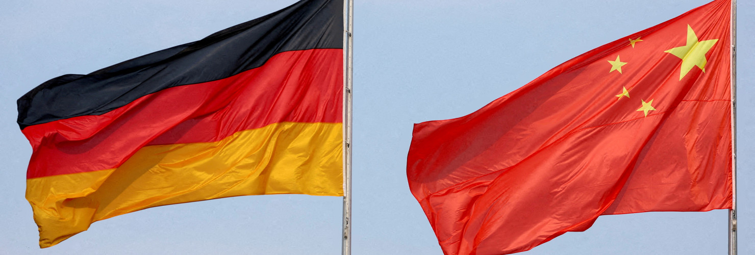 The flags of Germany and China are flying in the wind.