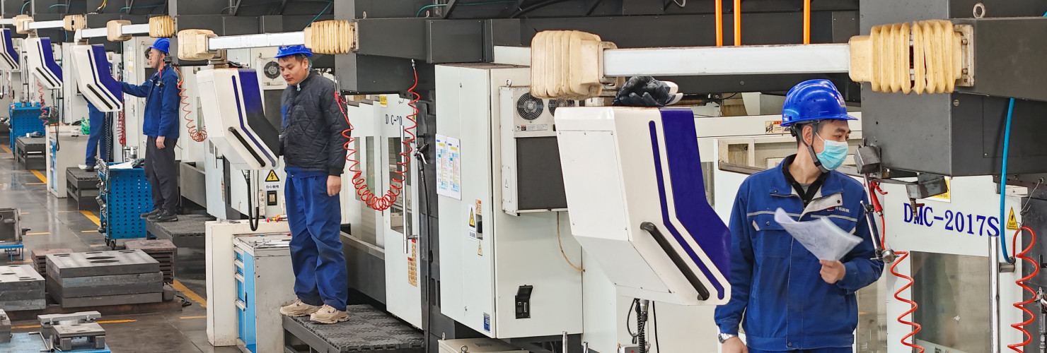 Workers produce slitting machine parts at Qingdao Kaisheng CNC Equipment Co., LTD., in Qingdao, Shandong province, China, November 28, 2024