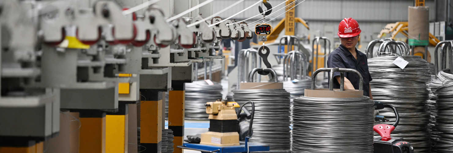  A worker produces bonding wire for domestic and international markets at a workshop in Jiangsu.