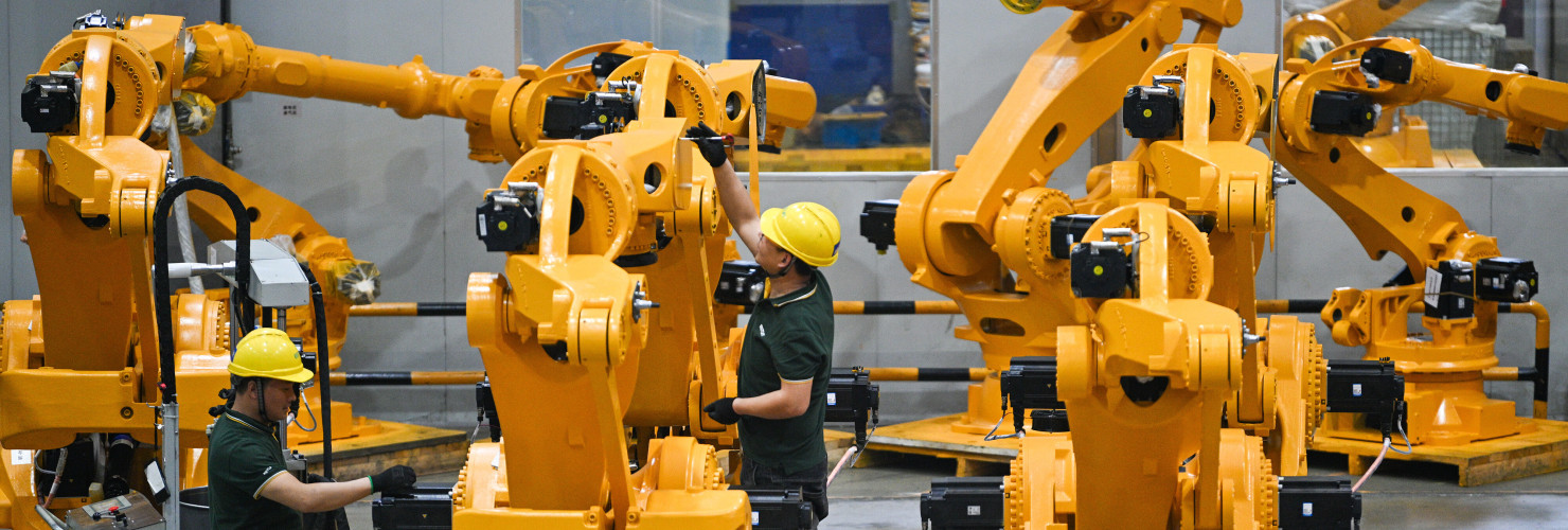 Workers assemble industrial robots at a robot manufacturer in Nanjing city in east China's Jiangsu province.