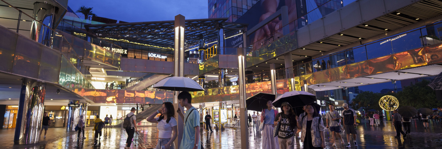 People shop at Taikoo Li Sanlitun in Beijing, China, Tuesday, July 2, 2024.