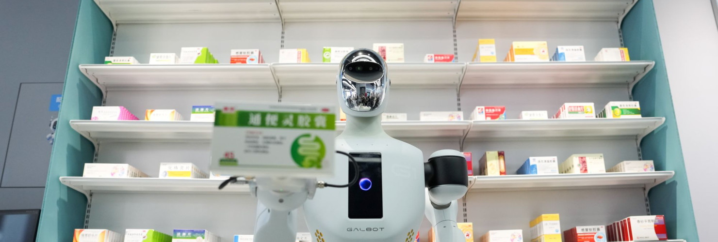 A Galbot humanoid robot plays the role of a shop assistant in a simulated pharmacy in Beijing Economic-Technological