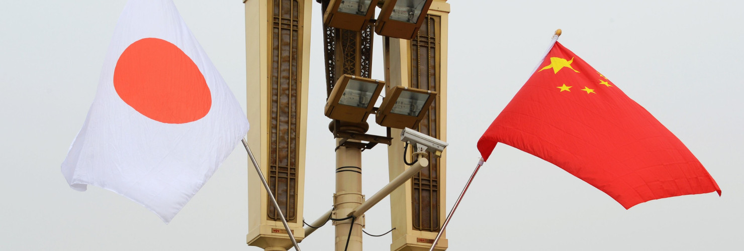 Chinese and Japanese flags flutter in the wind.