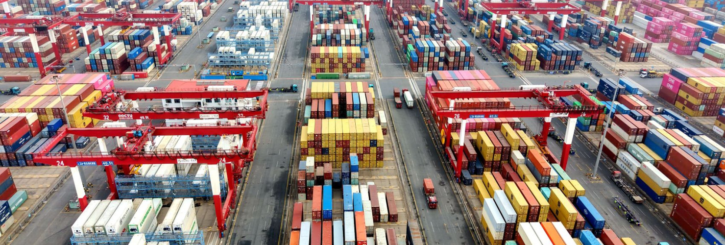 Vehicles are loading containers at Qingdao Port Foreign Trade Container Terminal in Shandong Province, China