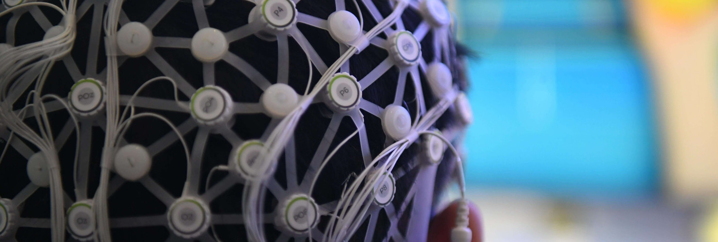 Person demonstrating a motor imagery brain-computer interface rehabilitation training system.