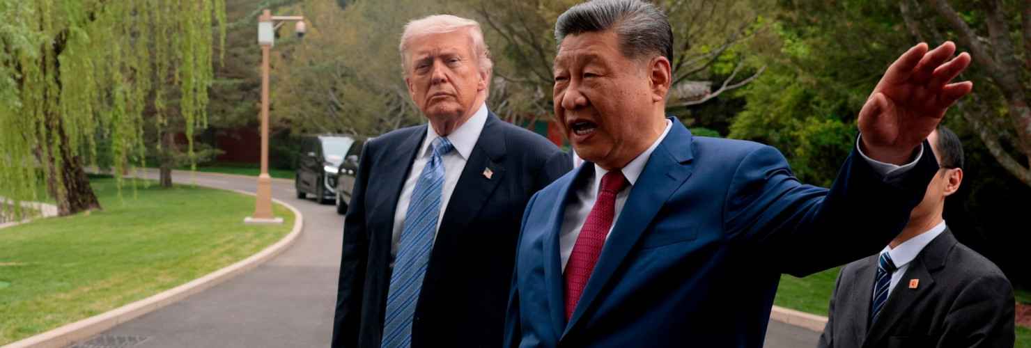 Chinese President Xi Jinping, center, gestures as he greets U.S. President Donald Trump at Zhongnanhai Garden in Beijing, Friday, May 15, 2026.