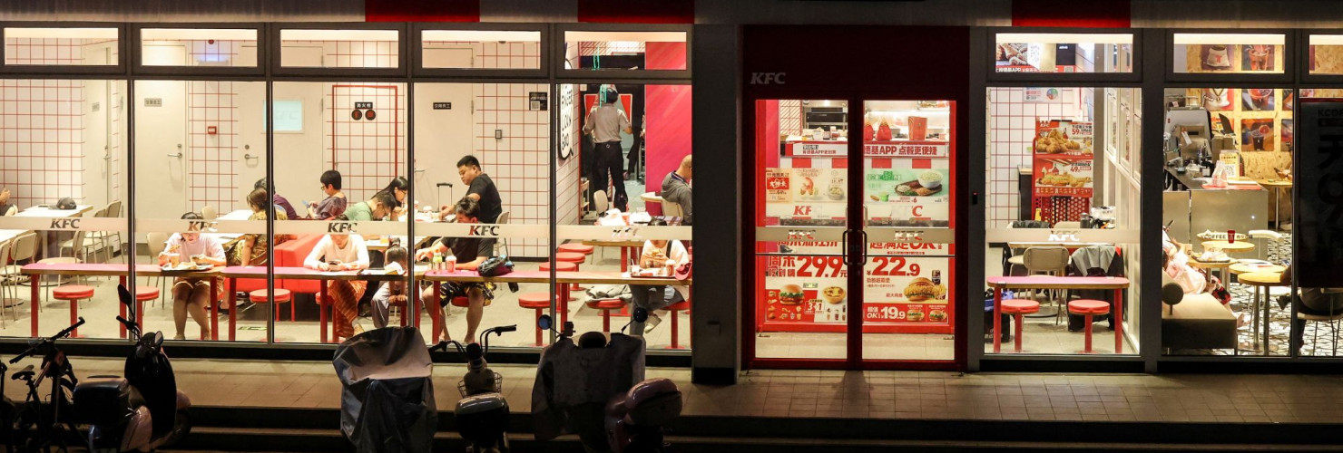 Customers dine inside a two-storey restaurant complex housing a KFC outlet on the ground floor and other restaurants on the upper floor in Beijing, China, July 12, 2026. REUTERS/Maxim Shemetov