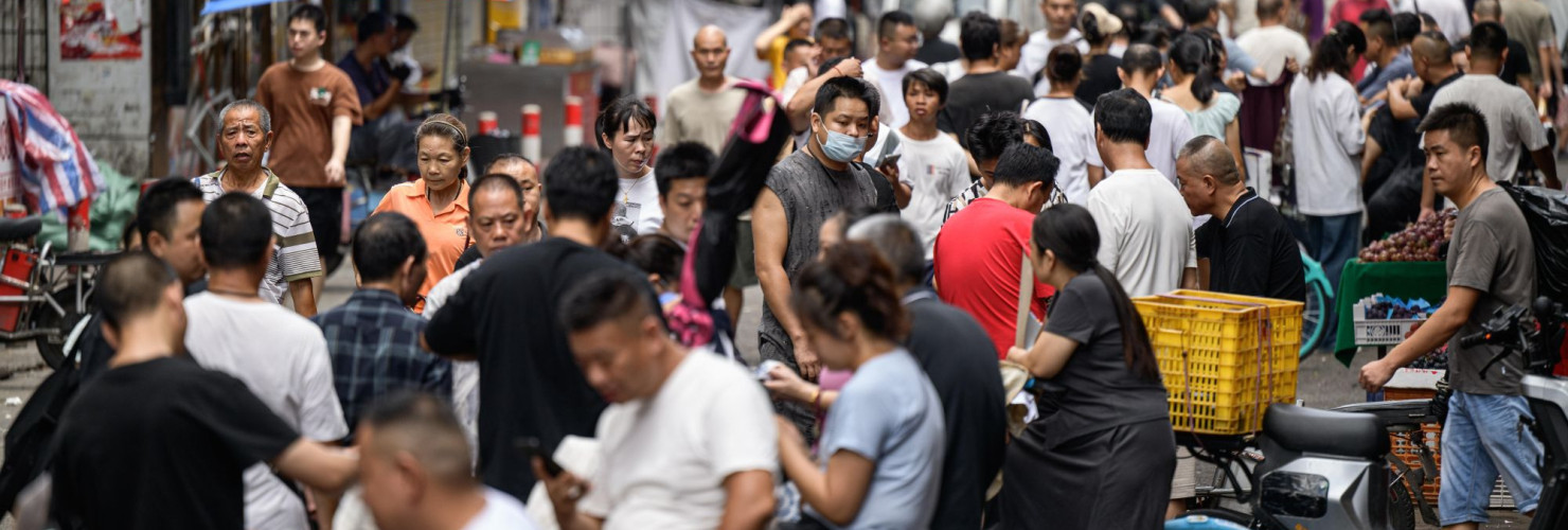 : A view of the street, where recruitment takes place in Datang Village, functions as a central labor market for the garment industry in urban villages in Guangzhou, China on July 11, 2025