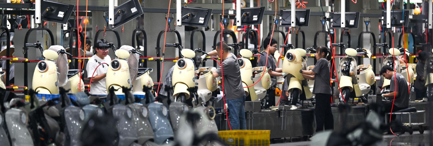 Workers assemble electric two-wheelers at AIMA Technology's production line in Tongliang District, southwest China's Chongqing, June 17, 2026.