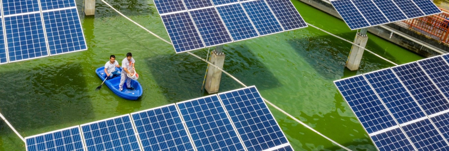 Aerial view of the fishermen working at a fishing area where photovoltaic power panels are used to generate power in Wuzhou city, south China's Guangxi Zhuang autonomous region