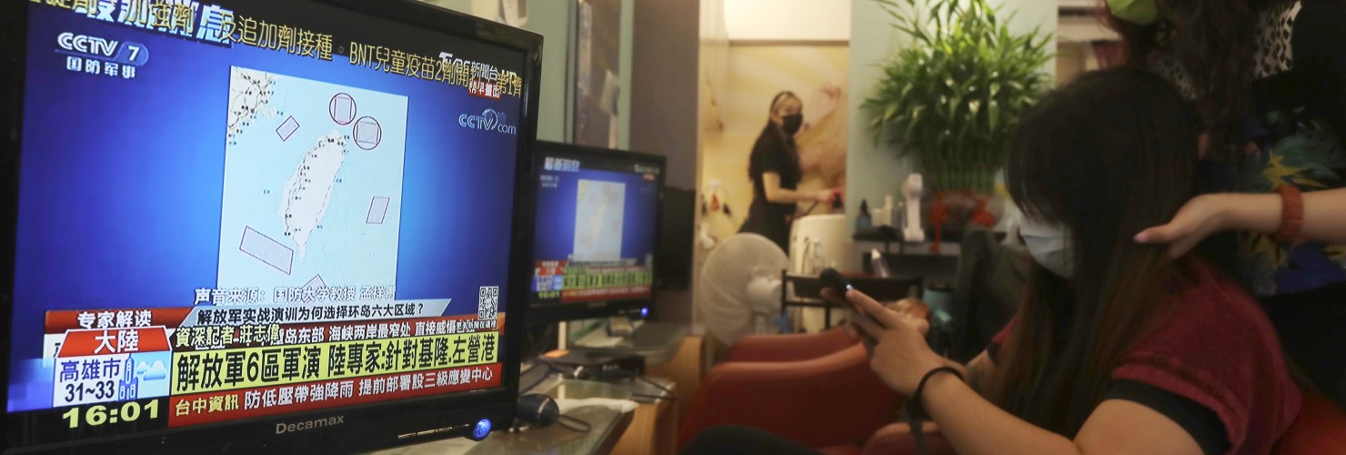 A TV news shows a map marking the areas where China is conducting live fire exercises near Taiwan, at a beauty salon in Taipei, Taiwan, Thursday, Aug 4, 2022