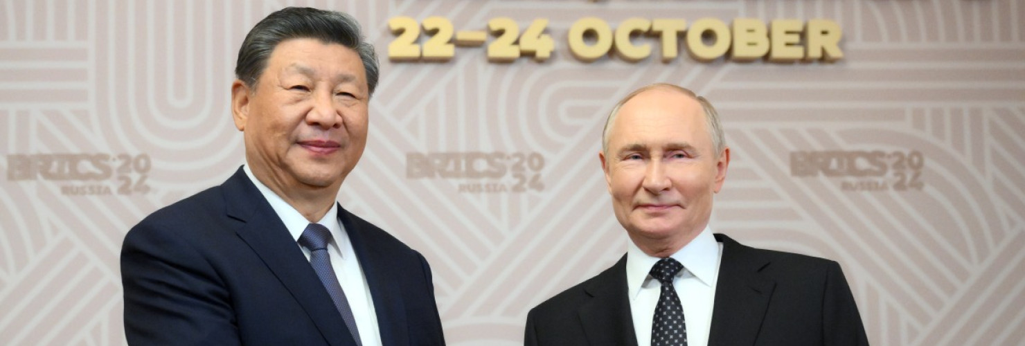 Russian President Vladimir Putin, right, welcomes Chinese President Xi Jinping, for the 16th BRICS summit at the Kazan Kremlin