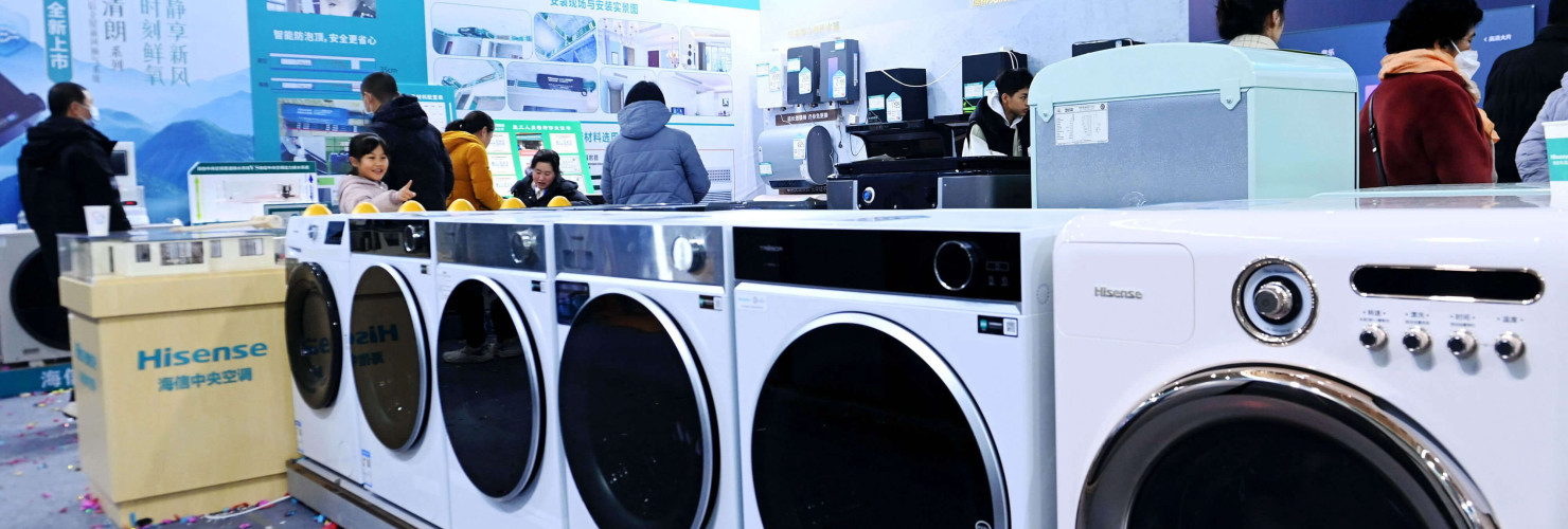 Chinese citizens look at home appliances. The Chinese government introduced trade-in programs on costlier household purchases like washing machines and fridges to lift consumption in Q2 2025.