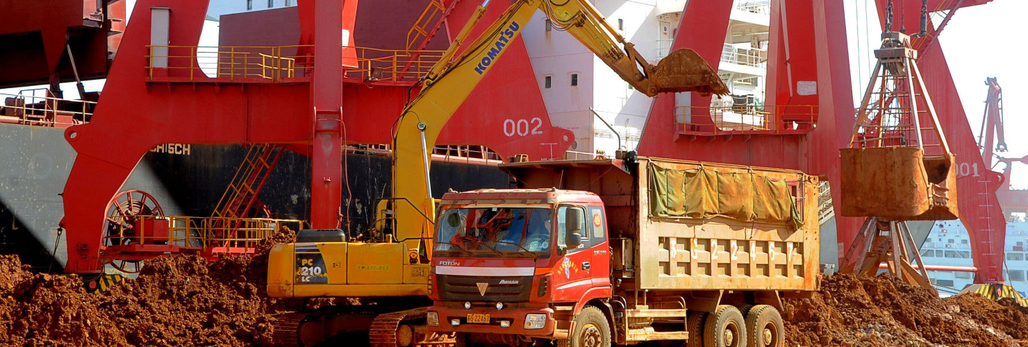 -An excavator loads a truck with rare earth on a quay at the Port of Lianyungang in Lianyungang city, east Chinas Jiangsu province, 10 March 2013.