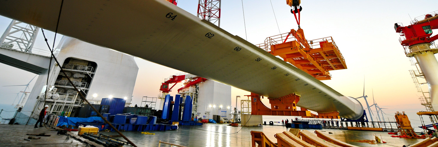 This photo taken on Jan. 13, 2026 shows one of the turbine blades being hoisted at the construction site of a 20-megawatt offshore wind turbine unit in the coastal waters of southeast China's Fujian Province. 