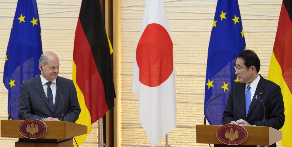 German Chancellor Olaf Scholz, left, listens to his Japanese counterpart Fumio Kishida during a joint press conference in Tokyo, Thursday, April 28, 2022.