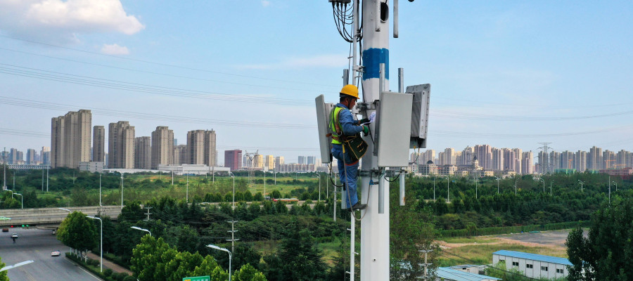 An employee of China Mobile Communications Group checks a 5G base station tower