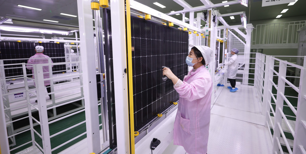 A worker at a photovoltaic company works on a production line in Lianyungang City, Jiangsu Province, China, December 15, 2023.