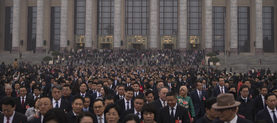 Delegates leave the Great Hall of the People after attending the closing ceremony of the National People's Congress in Beijing, Tuesday, March 11, 2025. 