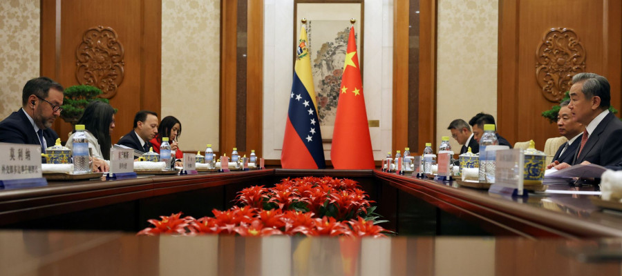 Chinese Foreign Minister Wang Yi, right, and Venezuelan Foreign Minister Yvan Gil Pinto, left, attend a meeting at the Diaoyutai State Guesthouse in Beijing, Monday, May 12, 2025.