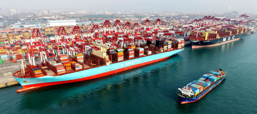 A cargo ship is loading and unloading foreign trade containers at the Qingdao Port Automated Terminal in Shandong Province, China on January 14, 2026