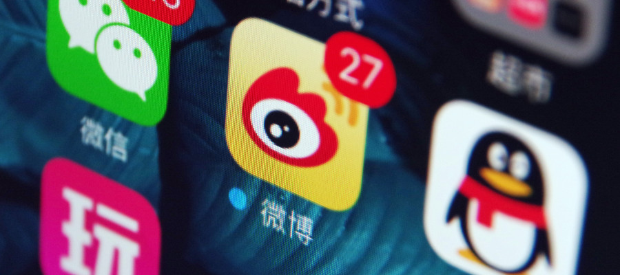 Icons of the messaging apps Weixin (WeChat), left, QQ, right, and Weibo, center