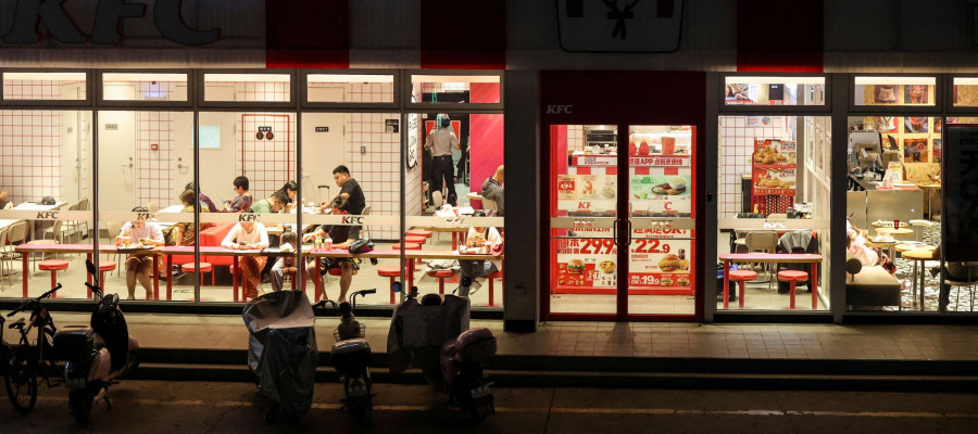 Customers dine inside a two-storey restaurant complex housing a KFC outlet on the ground floor and other restaurants on the upper floor in Beijing, China, July 12, 2026. REUTERS/Maxim Shemetov