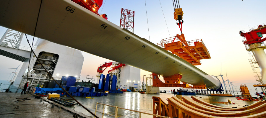 This photo taken on Jan. 13, 2026 shows one of the turbine blades being hoisted at the construction site of a 20-megawatt offshore wind turbine unit in the coastal waters of southeast China's Fujian Province. 