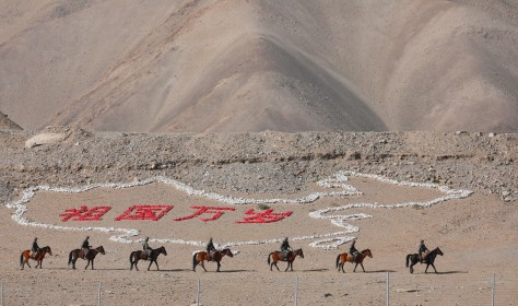 Border guards climbed over the obstacle on horseback. Kashgar City, Xinjiang 