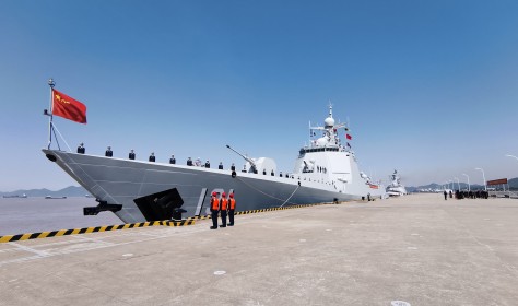 Officers and soldiers of the Chinese naval fleet for escort mission line up on the deck at a port.