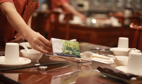 Staff at a local restaurant put up signs with characters saying "Clean Plate Campaign" to urge people against food waste, Yangzhou city, east China's Jiangsu province.