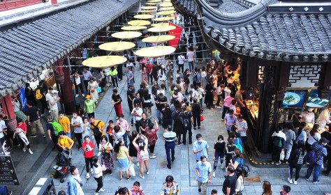 People enjoy the scenery near Yu Garden, a tourist attraction in Shanghai, China, 3 October 2020.