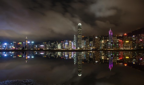 Night view of skyscrapers and high-rise buildings in Central along the Victoria Harbor in Hong Kong