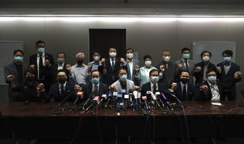 Hong Kong's pro-democracy legislators pose for a photo before a press conference at the Legislative Council in Hong Kong, Wednesday, Nov. 11, 2020.